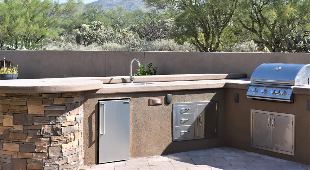 Outdoor kitchen with grill in a desert backyard Outdoor kitchen with grill in a desert backyard