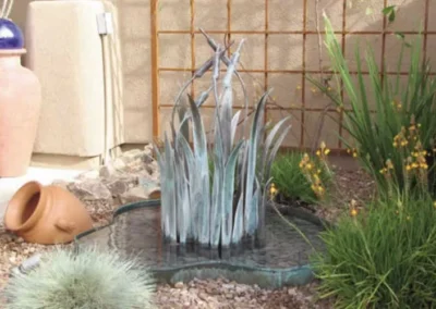 Abstract Metal Fountain With Glass Blades And Agave