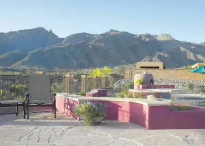 Backyard Patio With Mountain View, Seating Area, And Decorative Wall