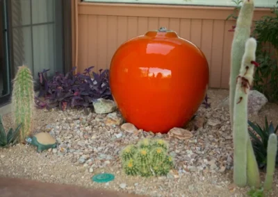 Bright Orange Ceramic Pot In Tucson Xeriscape