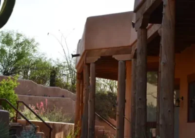 Covered Adobe Porch In Tucson With Desert Plants