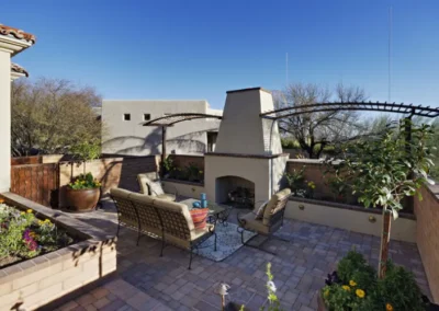 Cozy Patio Space Featuring Fireplace Seating And Decorative Pergola Structure