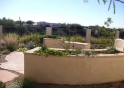 Modern Curved Planter Bed With Desert Landscaping And Stone Path