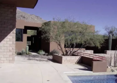 Modern Desert Home Entrance With Retaining Walls And Landscaped Yard