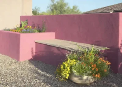 Modern Stucco Garden Wall With Built In Bench And Colorful Flowers