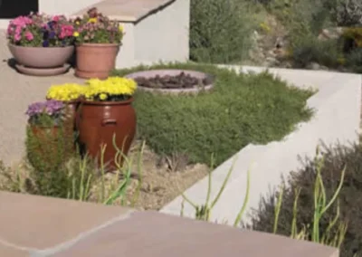 Raised Garden Bed With Potted Flowers And Stucco Retaining Wall