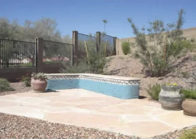 Raised Patio Seating Area With Decorative Fence And Stucco Retaining Wall