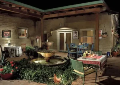 Southwestern Style Stucco Home With Spotlighted Palm And Cactus In Tucson Front Landscape