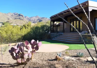 Tucson Backyard With Curved Stone Steps, Circular Flagstone Patio, Artificial Turf, Purple Prickly Pear Cactus, Agave, And Desert Mountain Views