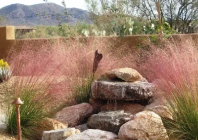 Tucson Boulder Water Fountain Against Pink Stucco Wall