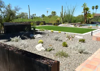 Desert backyard landscaping with gravel garden, cactus plants, and modern outdoor design