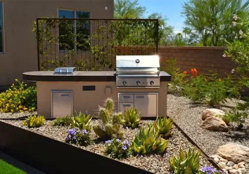 Outdoor kitchen with grill in desert backyard
