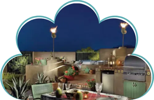 Outdoor kitchen and patio dining area at night