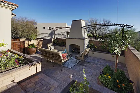 Outdoor patio with fireplace and seating area