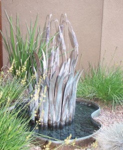 Stylish metal fountain with water feature