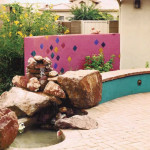 Colorful Screen Wall and Seatwalls with Waterfall at Brick Patio