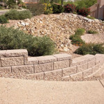 Allan block retaining wall at colored exposed aggregate concrete driveway | 2008 ALCA Judges Award