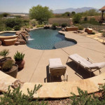 Retaining Wall with flagstone cape at colored exposed aggregate concrete pool deck | 2007 ALCA Award of Distinction