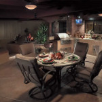 Outdoor kitchen and dining area with colored stamped concrete | 2007 APLD Gold Award